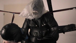 Standing bondage in leather straitjacket